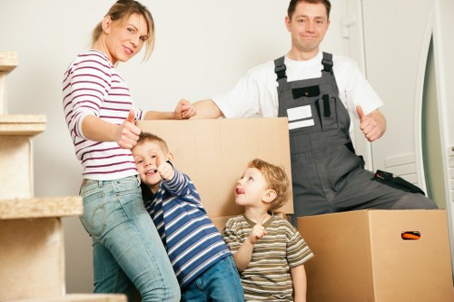 Removal team handling furniture during a house move in Walworth